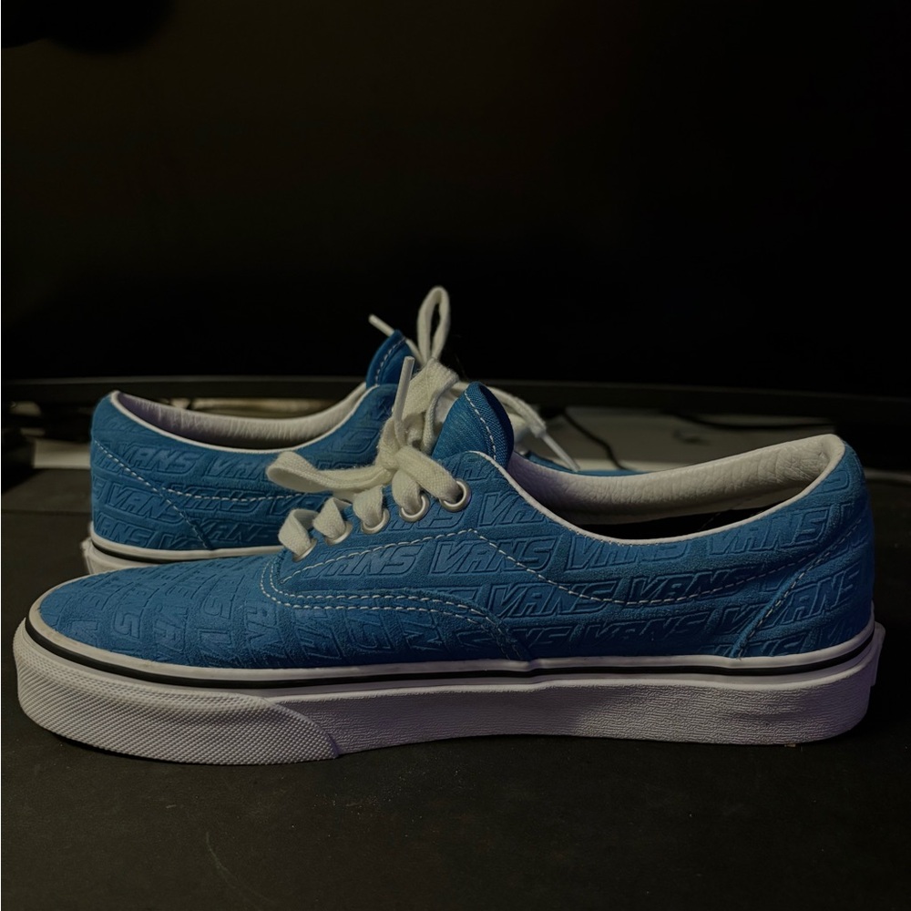 Blue Vans Era sneakers.